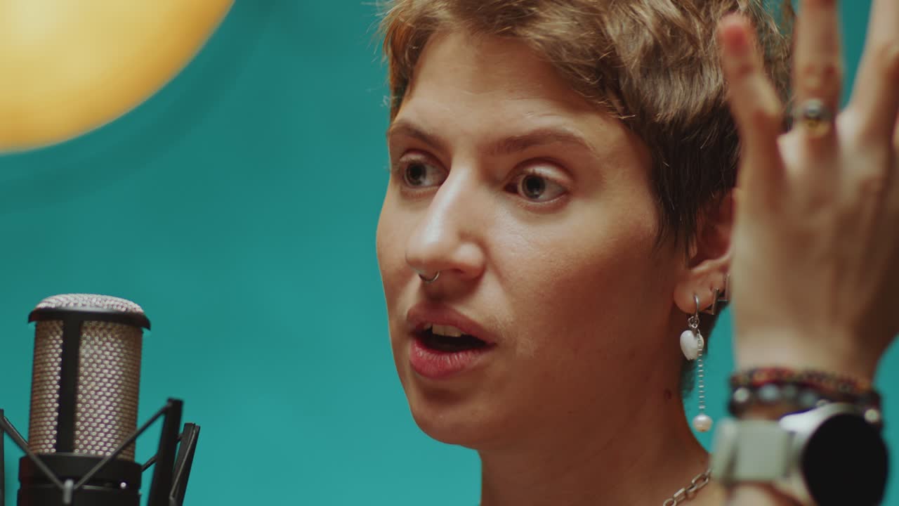 Young Woman Speaking into Microphone during Podcast Interview
