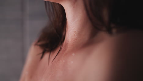 young woman with problematic skin stands in shower. naked lady waits for skin to dry to get out of bathroom. bare woman with acne stands in bathroom