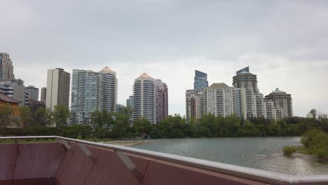 City-skyscraper-by-river-Memorial-Drive-pan-Calgary-Alberta-Canada