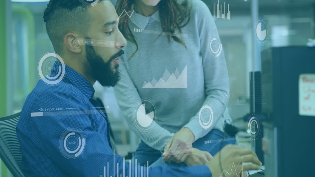 Analyzing digital graphs and charts, business professionals collaborating in office