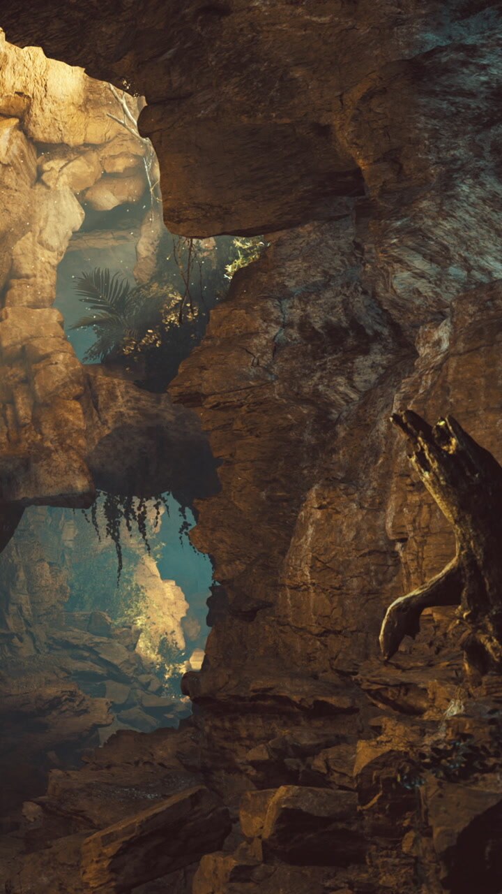 Exploring a cave with large rocks and plants in a natural setting