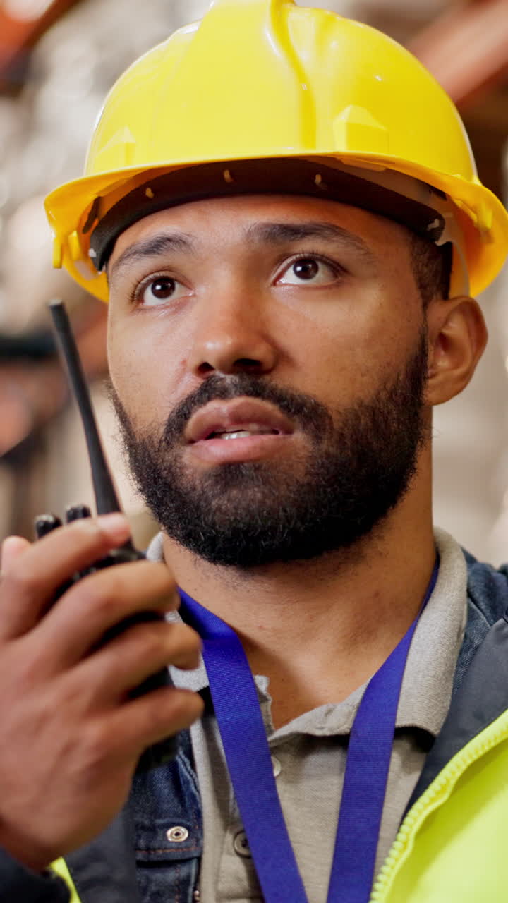 Construction worker using a walkie-talkie in a warehouse