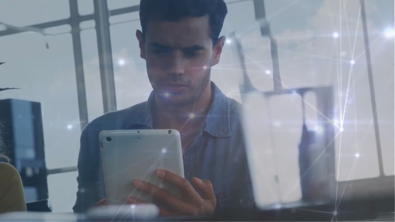 Animation of network of connections over biracial businessman using tablet in office