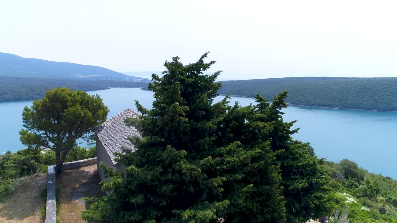 Rising shot revealing boats anchored in the Pula sea beside Rakalj village