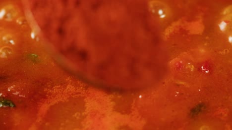 boiling tomato sauce on a frying pan close-up. cooking tomato sauce or soup. traditional italian mexican asian dish. high quality studio shot for cafe, restaurant close up. marinara sauce for italian pasta
