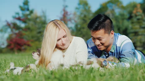 Young-Couple-Play-With-Puppies