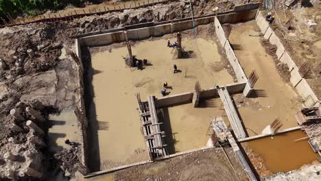 aerial view of construction site with workers in muddy water
