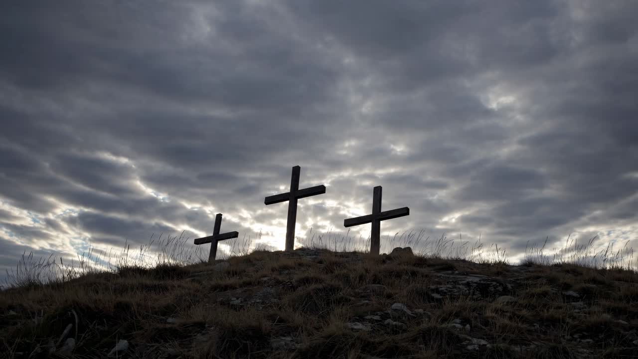 Dramatic video scene of three crosses on a hill under a moody sky
