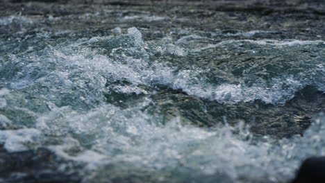 mountain river water flowing in slow motion. powerful stream in mountain river.