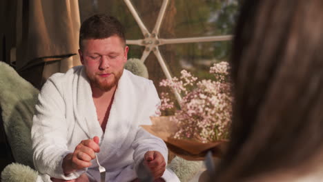 couple enjoying breakfast in a glamping bubble