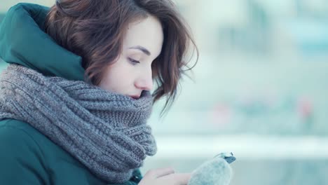 woman using phone in winter