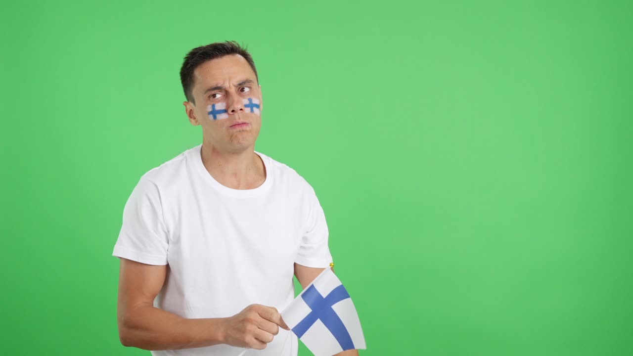 Nervous man cheering for Finland during a match looking away