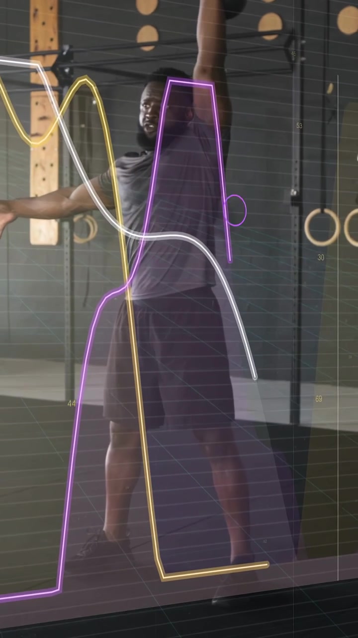 Vertical video: Man picking kettlebell in gym doing clean or press or squat with overlay tracking me