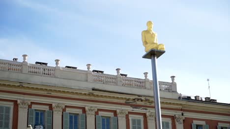 gold statue on a pole in a city