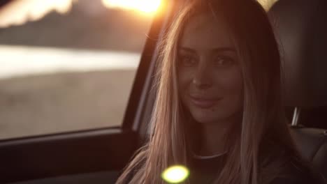 Beautiful-woman-lookingto-the-camera-from-the-car-then-go-out-from-the-car-seat-to-the-seashore