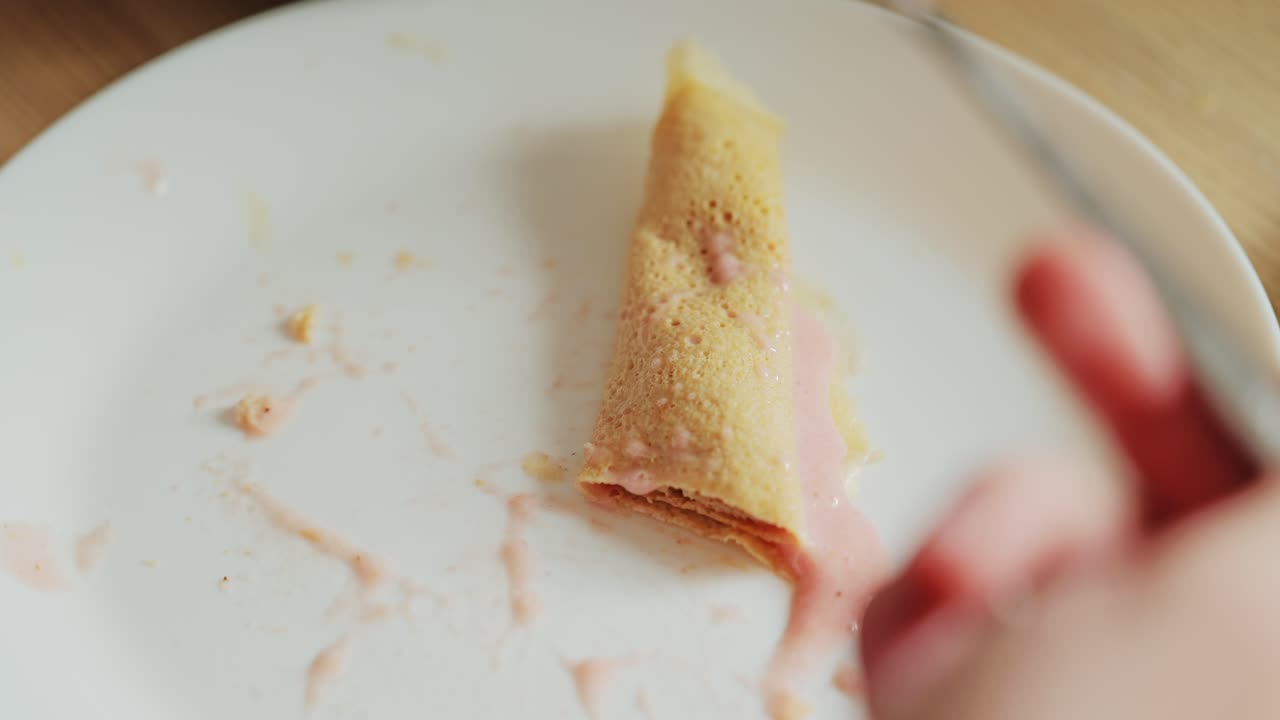 Soft pancake filled with strawberry cream evokes comfort and nostalgia