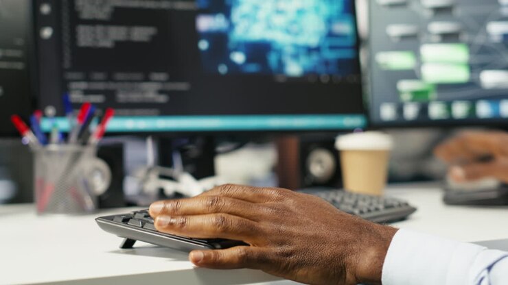 Data center computer scientist at desk using AI deep learning algorithms
