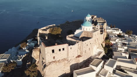 aerial view of a castle and church on a greek island