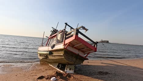 a boat rests on pattaya's sandy shore