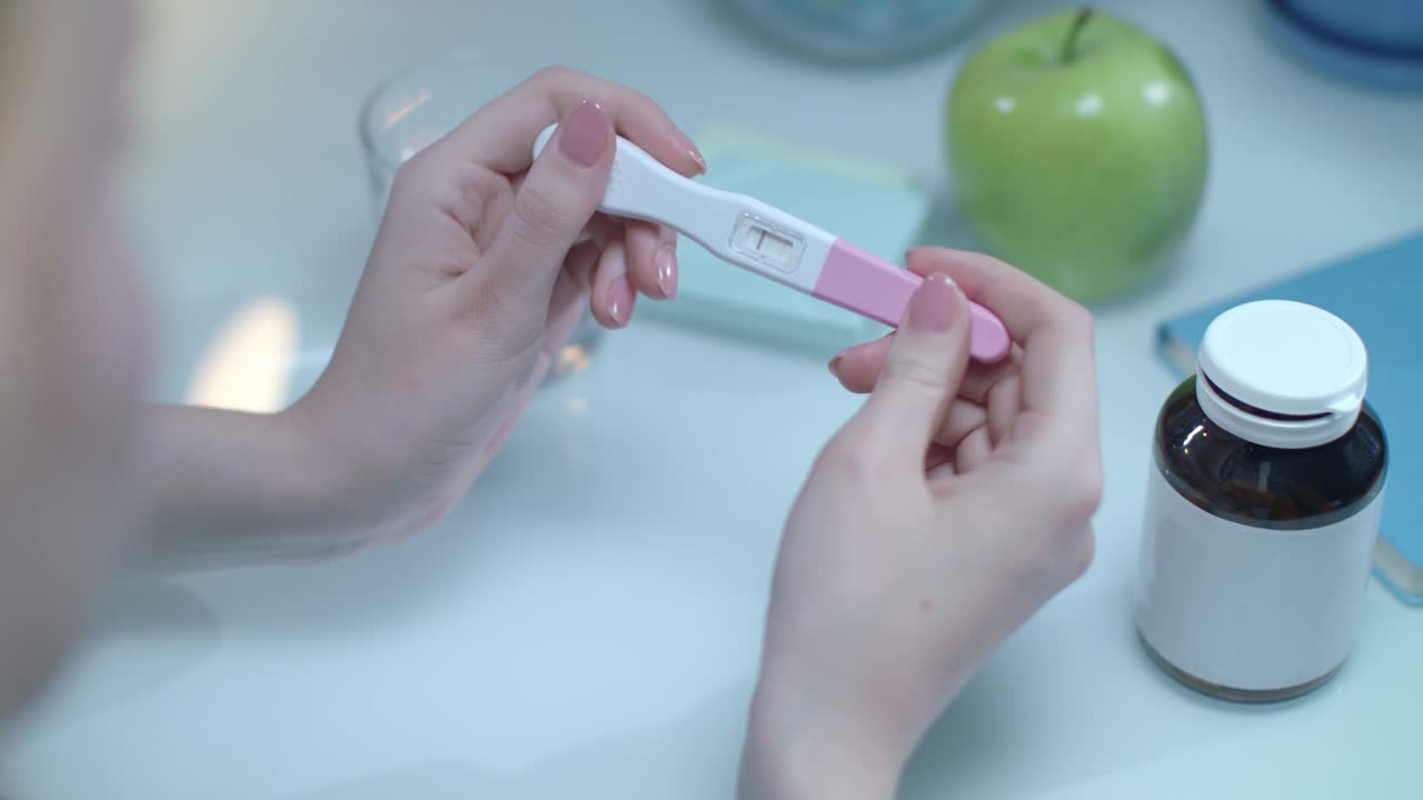 Positive pregnancy test in female hands. Test pregnacy with one line