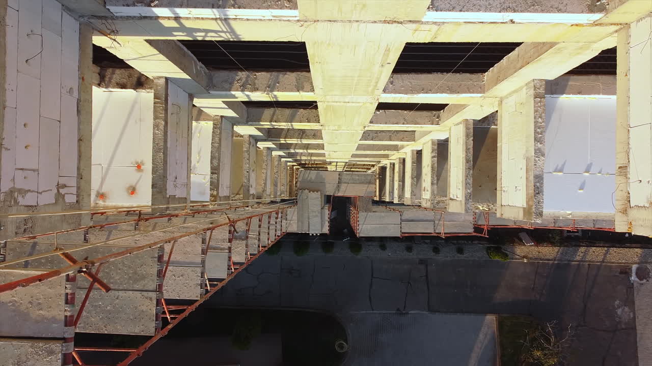 Construction works of a building with scaffolding on the facade. View from the drone. Bucharest, Romania