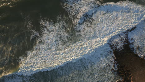 Top-down-shot-of-waves-breaking-at-Ericeira-Portugal