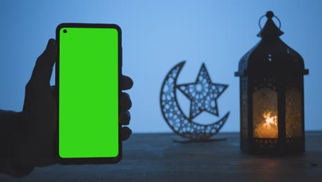 Wide-Shot-of-Lantern-Dates-and-Water-with-Green-Screen-Phone-at-Dusk