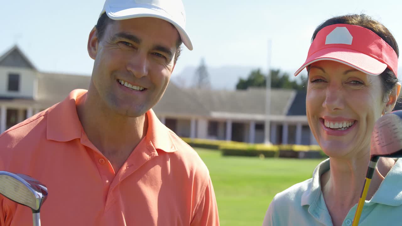 골프 클럽 을 들고 서 있는 미소 짓는 부부 의 초상화