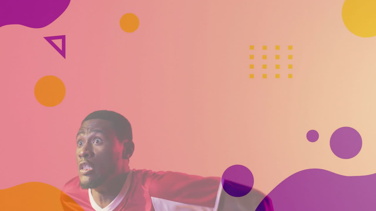 Man wearing red jersey showing surprise while floating geometric shapes over backdrop for tech ads