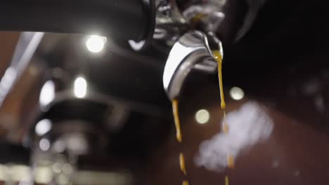 Fresh espresso flowing from Italian, steal coffee machine