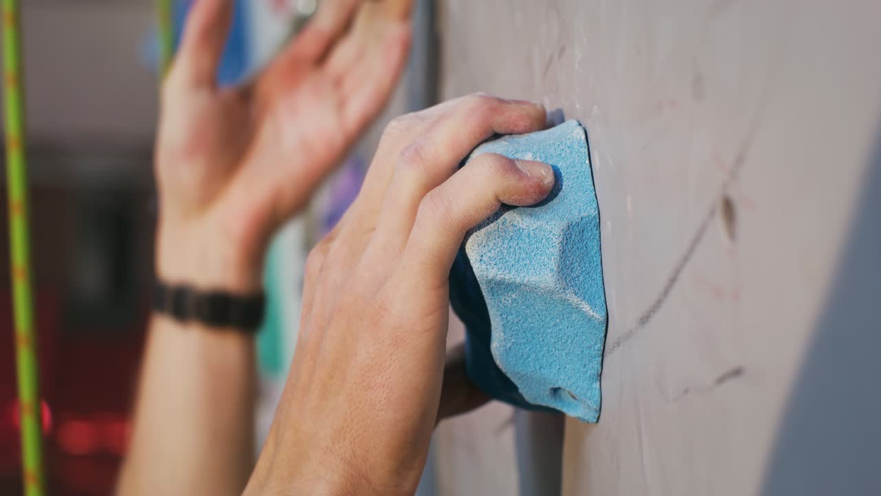 Person Climbing on an Indoor Bouldering Wall