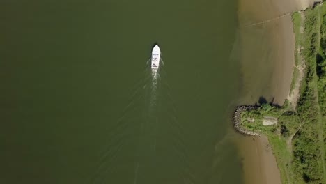 aerial drone view of top-down shot over the boat at the river in europe