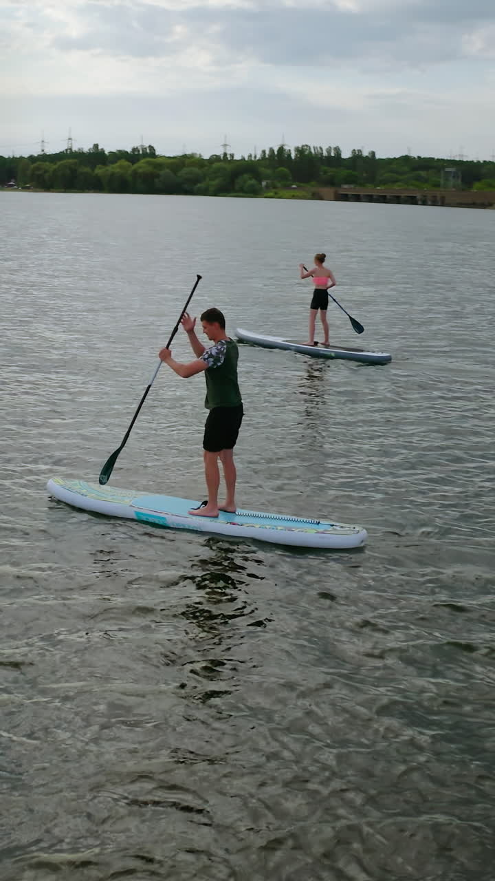 Standup paddle board surfing. People standing firmly on SUP board and paddling