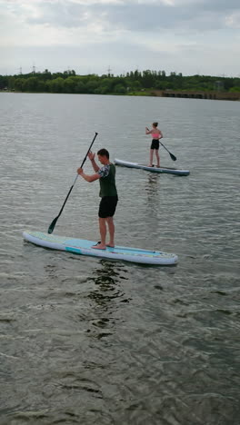 Standup paddle board surfing. People standing firmly on SUP board and paddling