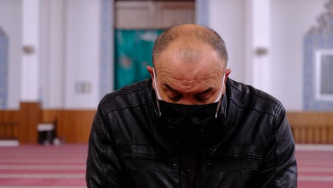 old man wears mask and turns his head mosque ramadan moon