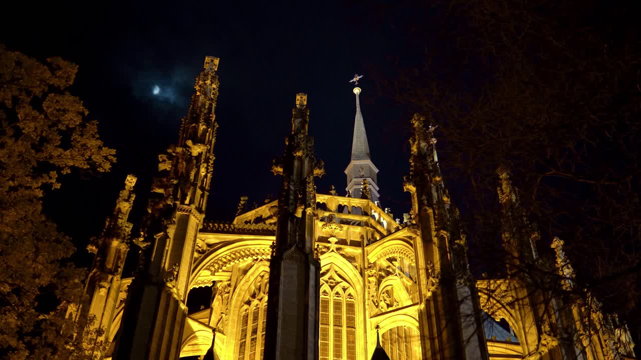 Saint Barbara's Church towers with Moon at night, Kutna Hora, Czechia, truck left