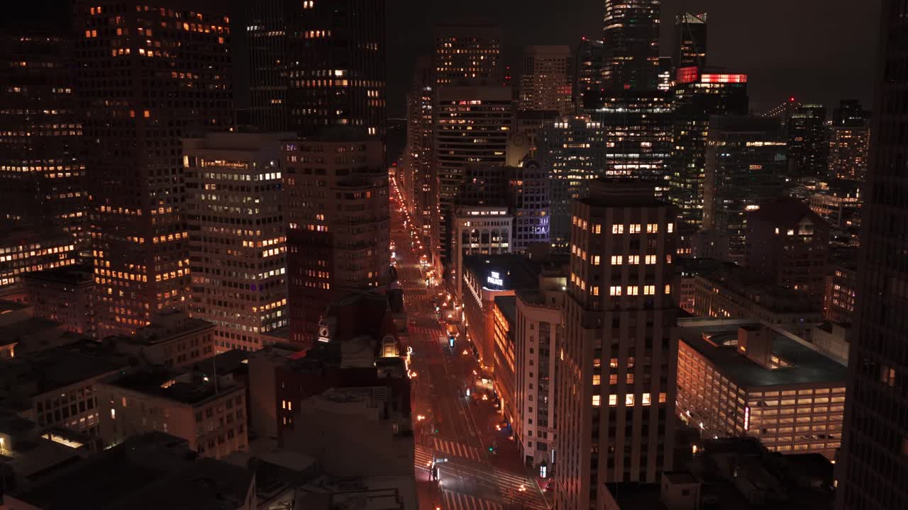 Wide panning aerial shot of Market Street at night near Union Square in San Francisco, California. 4K