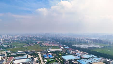 aerial view of the outskirts of danyang city in jiangsu province, china, during the daytime, showcasing a blend of urban and rural landscapes of developed areas.