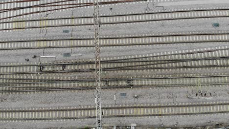 Rising-drone-footage-of-train-tracks-in-Colchester,-Essex,-UK