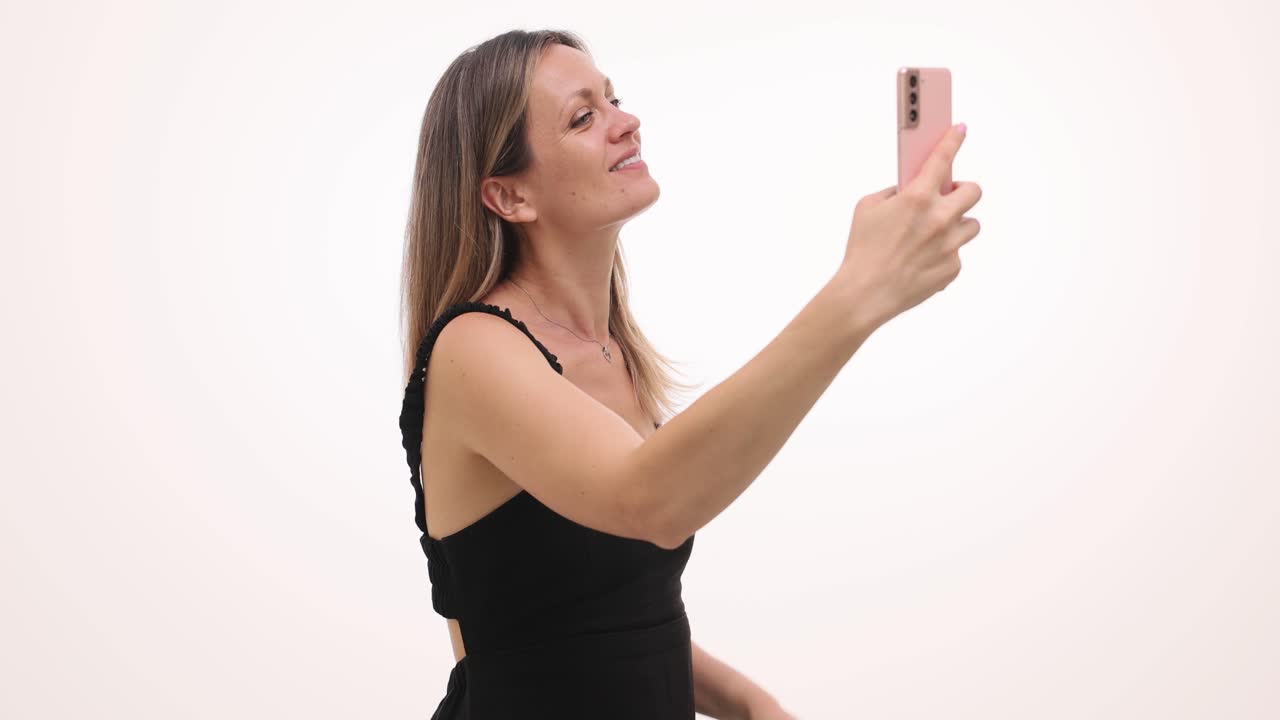 A woman takes selfies, making different expressions