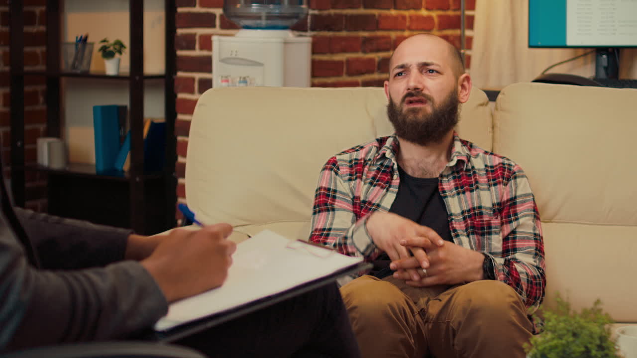 African american counselor consulting man at therapy session