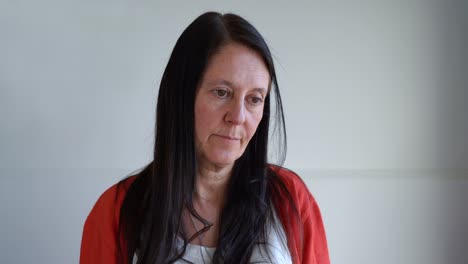 middle age woman shaking head putting her hands on face feeling sorry standing against white background