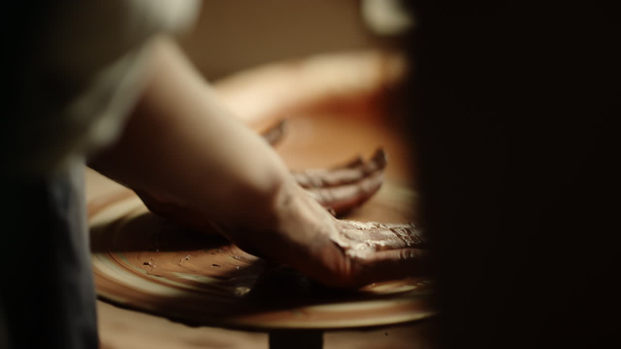 Lady ending handicraft process in pottery. Woman hands having rest in workshop