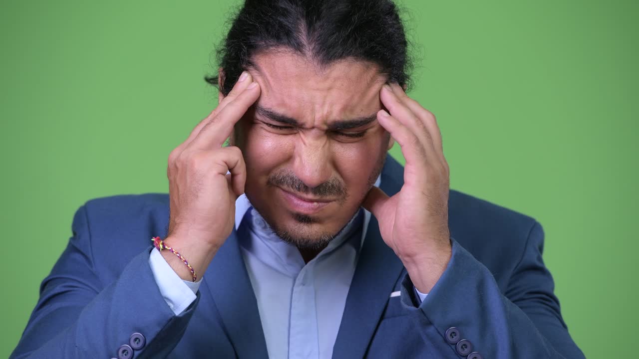 Stressed businessman having headache