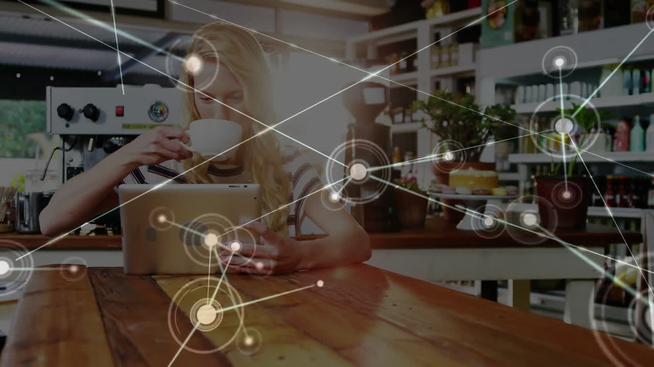 Woman drinking coffee and using tablet with network connections animation overlay
