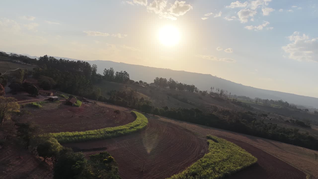 Dramatic Sunset Sky at Scenic Green Valley Mountains. Rural Life Scene. Sunset Countryside Scenery. Golden Hour Sunset Landscape. Colorful Sunset Sky Clouds