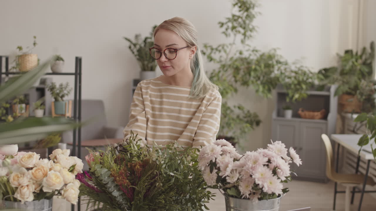 Woman Florist Arranging Flowers in a Shop