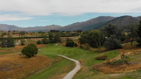 SLOWMO---Female-golf-player-hitting-ball-at-golf-course-in-New-Zealand---Aerial