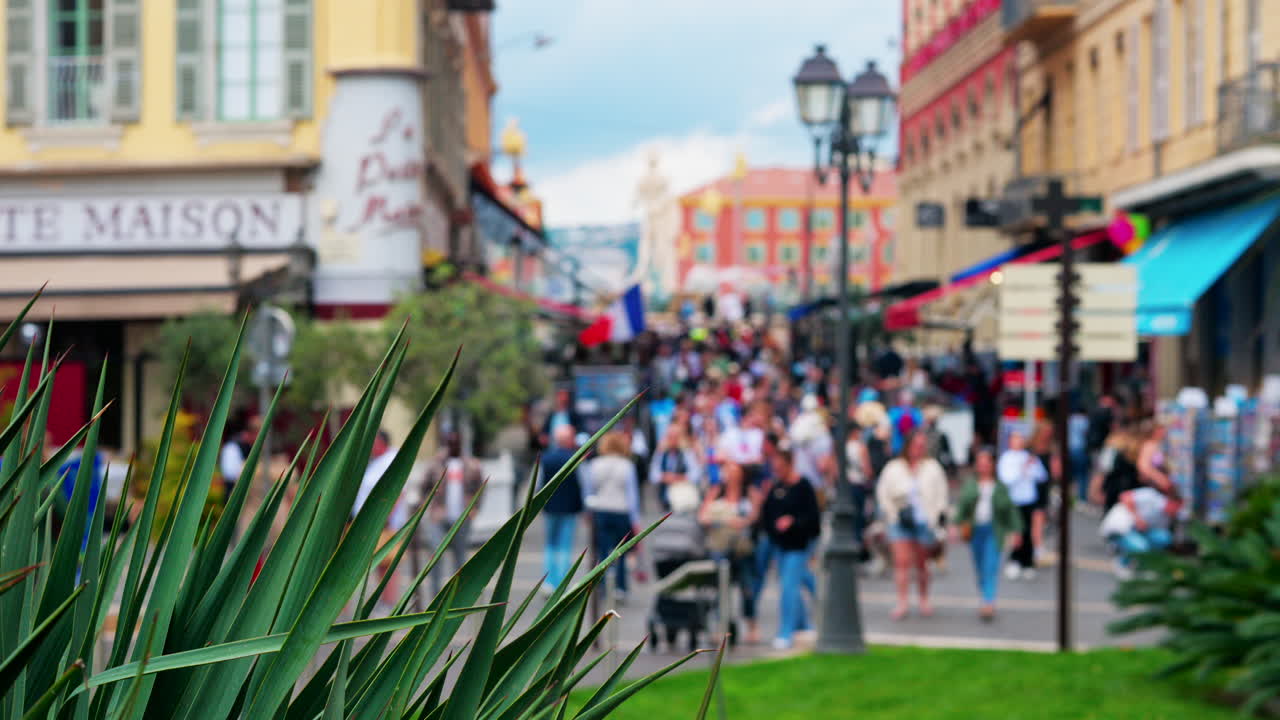 Nice, France - May 12, 2025: People walking through the Massena Square in daylight
