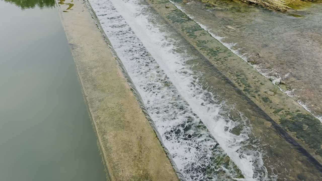 Waterfall cascading over concrete steps